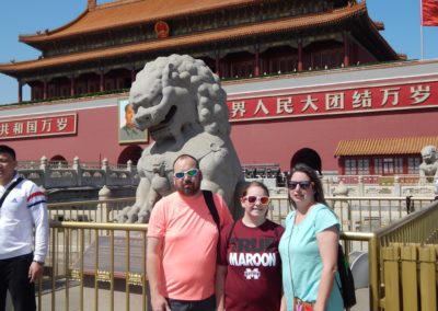 Family in front of Chinese lion statue, China adoption travel